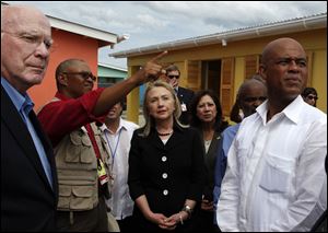 Secretary of State Hillary Rodham Clinton, center, accompanied by, from left, Sen. Patrick Leahy, (D., Vt.),  Caracol Ekam Housing site engineer Mario Nicoleau, Labor Secretary Hilda Solis and Haitian President Michel Martelly, tours the Caracol Ekam Housing Site in Caracol, Haiti, Monday.