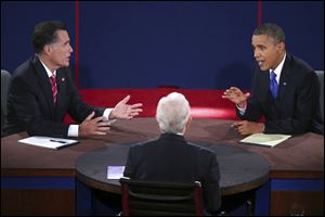 Republican presidential nominee Mitt Romney and President Barack Obama answer a question during the third presidential debate at Lynn University.