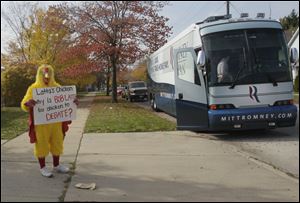 A man in a chicken suit holds a 