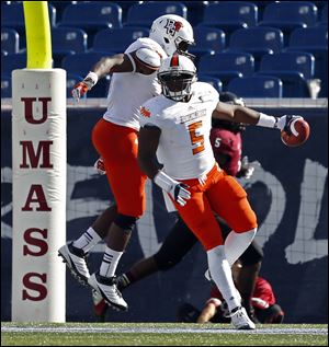 Bowling Green linebacker Dwayne Woods (5) celebrates with teammate Gabe Martin, left, after Woods intercepted a pass and ran it back for a touchdown in the third quarter of Saturday's game.