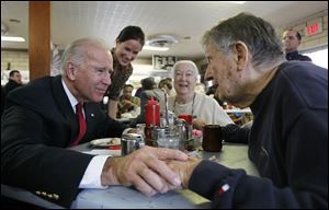 Vice President Joe Biden, with his daughter Ashley Biden, standing, talks with Ed Nazar and his wife Ann Monaghan Nazar during a campaign stop Tuesday at Schmucker's restaurant in Toledo.