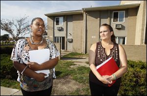 Kisha Vinson, left, and Delores Harmes, right, residents of the Greenbelt Place apartments in Toledo, talk following a meeting with HUD officials and apartment management.