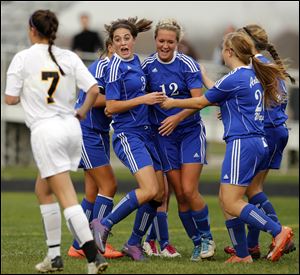 Anthony Wayne's Abby Allen (3), Katelyn Bixler (12), and Katie Coburn (20) celebrate Bixler's goal against Sylvania Northview during a Division I girls district soccer semifinal Tuesday at Timberstone Junior High.
