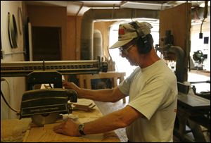 Ten months after National Machinery shuttered in 2001 and
laid off hundreds of workers, Gene Goshe took a job for $10 an hour with no benefits at a local lumberyard.