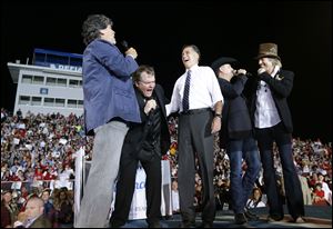 Republican presidential candidate and former Massachusetts Gov. Mitt Romney sings 