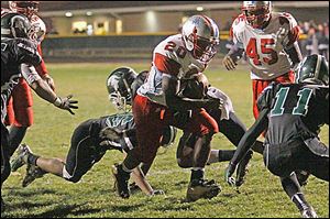 Bowsher's junior Khane Collins pushes past the Start defensive line during the first quarter at Start on Friday.