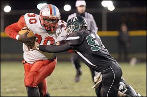 Bowsher senior Pharaoh Reid attempts to hold off a Start defender while rushing during the first half at Start.