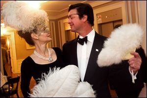 Condessa Croninger, left, and Eric Hillenbrand, right, strike a dramatic pose during the Blue Moon Ball at the Toledo Club.