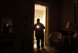 During an overnight stay earlier this month, reporter Kirk Baird uses a flashlight to illuminate areas of a room in the Mansion View Inn in the Old West End that is purported to be haunted.