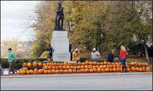 Carved pumpkins line the sidewalk in front of the Commodore Perry statue in downtown Perrysburg.