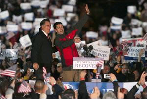 Republican presidential candidate Mitt Romney (left) and his running mate Rep. Paul Ryan, R-Wis. wave to supporters Friday at North Canton Hoover High School in North Canton.