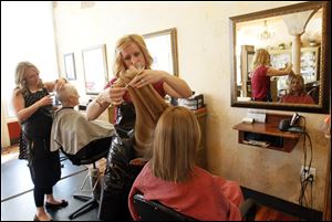 Styist Jamye Speelman, left, cuts Kate Kelley's hair at  Ahava Spa and Wellness Center.