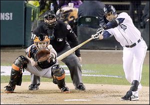 Tigers second baseman Omar Infante hits a single during the fifth inning of Game 3. Detroit's rally stalled when Miguel Cabrera popped out with the bases loaded.