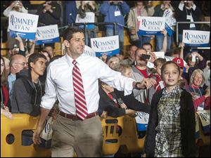 Republican vice presidential candidate Paul Ryan greets the crowd with his daughter Liza before a rally Saturday in New Philadelphia, Ohio.