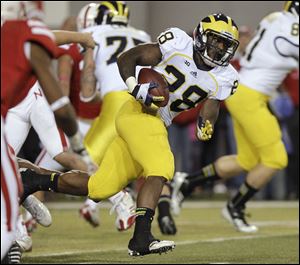 Michigan's Fitzgerald Toussaint carries the ball against Nebraska.