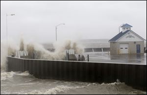 Waves crash over the Miller Boat Line on Catawba Island, as the effects of Hurricane Sandy are felt along the Lake Erie coastline in Ottawa County.