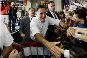 Republican presidential candidate, former Massachusetts Gov. Mitt Romney greets supporters as he campaigns at Avon Lake High School in Avon Lake, Ohio, today.