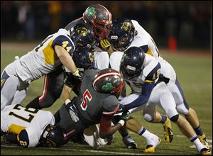 The Whitmer defense shuts down Central Catholic's Paul Moses on Friday night. Whitmer won 42-0.