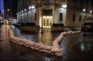 Sand bags protect an entrance of the New York Stock Exchange early Monday.