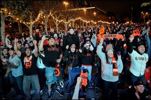 San Francisco Giants fans celebrate outside San Francisco's City Hall while watching a broadcast of the Giants facing the Detroit Tigers in Game 4 of the World Series.