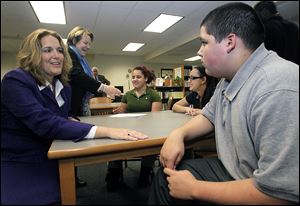 Kendra Kec, Lucas County Juvenile Court assistant court administrator, left, and court administrator Deborah Hodges, speak with eighth-graders Kailyn Jackson, Emily Escalante, center, and Manny Barnes at Reynolds School. The two girls are members of Young Women of Excellence; Young Barnes is a member of the Student African American Brotherhood.