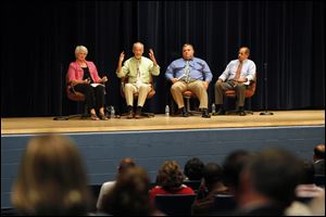 From the left, Ann Huss, William Donnely, Don Adamski and William Geha, all local emotional health professionals, talk with parents about risk and resilience in teens at Springfield High School.