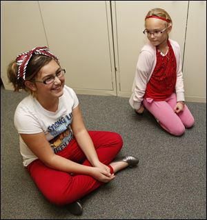 Eagle Point Elementary fourth graders, left,  Abby Britton-Lowden, 10, and Julie Siewert, 10, talk about letters they wrote to  Vietnam veterans who took a recent Honor Flight in Rossford, Ohio.