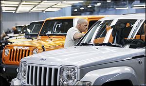  A worker looks over a Liberty at Chrysler's Toledo assembly complex this year.