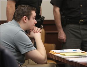 Brogan Rafferty waits for the start of morning proceedings  in the courtroom at the Summit County Common Pleas Court in Akron, Ohio.