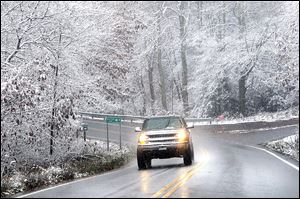 Snow sticking to tree limbs on Grandview Road in Beckley, V.Va. as superstorm Sandy wheeled toward land Monday.