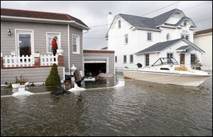 A boat floats in the driveway of a home in the aftermath of superstorm Sandy in Lindenhurst, N.Y. 