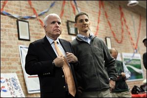 Arizona Senator John McCain and Ohio Treasurer and U.S. Senate candidate Josh Mandel listen to a question during the 