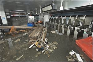 Employees from MTA New York City Transit work to restore the South Ferry subway station after it was flooded by seawater during superstorm Sandy.