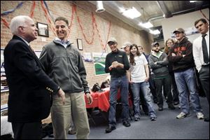 Josh Mandel laughs with Arizona Senator John McCain as McCain finishes speaking during the 