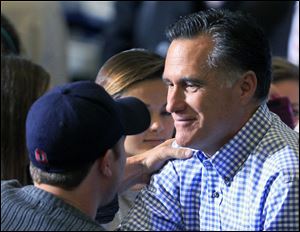 Republican presidential candidate Mitt Romney shakes hands with a supporter while collecting donations at a storm relief event, Tuesday at James S. Trent Arena in Kettering, Ohio.