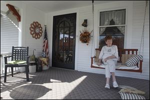 Obama supporter Corinne Hurni sits on her Hicksville, Ohio, porch on east Smith Street.