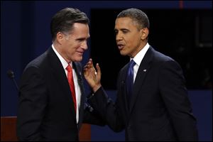 Republican presidential candidate former Massachusetts Gov. Mitt Romney and President Barack Obama talk after the first presidential debate at the University of Denver in Denver.
