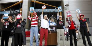 Staff members of The Toledo-Lucas County Public Library hold up letters that spell 