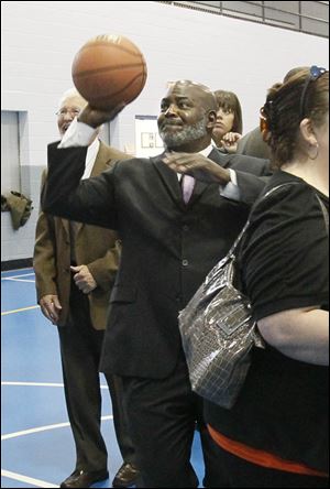 Toledo Mayor Mike Bell takes a shot at the hoop after a press conference announcing that a late-night basketball program is running for six weeks and is focused on providing positive alternative programming for teens and young adults.