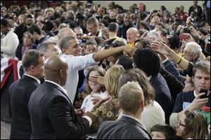 President Barak Obama shaking hands with the audience after his speech. 