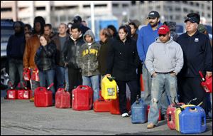 People line up at a gas station waiting to fill up in Newark, N.J. In parts of New York and New Jersey, drivers lined up for hours at gas stations that were struggling to stay supplied.