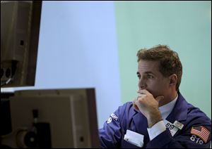 A trader works on the floor at the New York Stock Exchange in New York. 