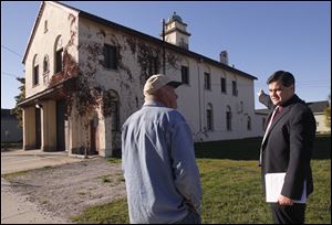Block watch captain Sy Kreais speaks with Toledo City Council president Joe McNamara outside Toledo Fire Station 3 in Toledo, to claim the station, built in 1927, can be saved. The city has already announced that, after a fault was found in the floor, the station would be replaced.