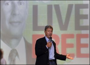 Libertarian presidential candidate Gary Johnson tells the crowd in Bowling Green that voting for him would rain on the two-party system. He spoke there downtown Friday.