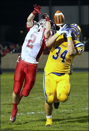 Patrick Henry's Derek Hoops (2) breaks up a pass intended for  Northwood's Nicholas Whitmore during the Division V football playoffs in Northwood on Saturday night.