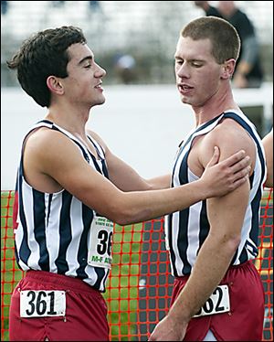 St. Francis runner Kyle Lach (361), left, greets teammate Dan Lenart (362) at the finish.