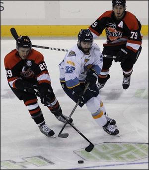 Walleye Cody Lampi is sandwiched between Ft. Wayne's Stephon Thorne (29) and Kaleigh Schrock during Friday night's game at the Huntington Center.
