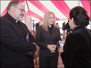 The Rev. Martin Otto Zimmann and his wife, the Rev. Angela Zimmann, talk to Dr. Mahjabeen Islam, president of the Islamic Center of Greater Toledo. Ms. Zimmann is running for Congress. 