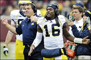 Michigan head coach Brady Hoke, left, and quarterback Denard Robinson, right, need to end the season strong and hope Nebraska stumbles to win the Legends Division.