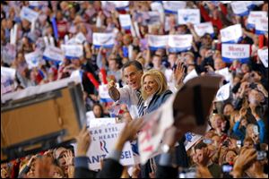 Presidential candidate and former Massachusetts governor Mitt Romney with his wife, Ann, greet the crowds during a campaign rally at the I-X Center in Cleveland.
